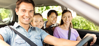 Family of four in the car ready to drive to their conveniently scheduled appointments