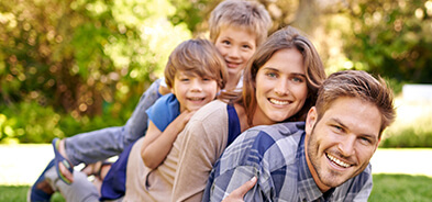 Carefree mom, dad, and two sons playing outside