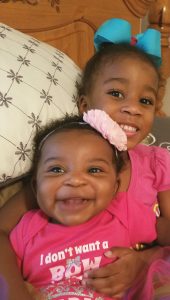 Dr. Jones's two young daughters demonstrating good dental hygiene for kids