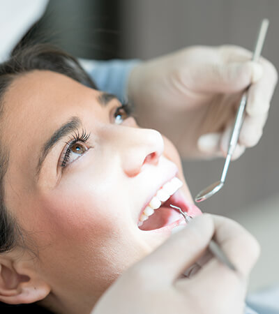 woman having her teeth examined by her dentist