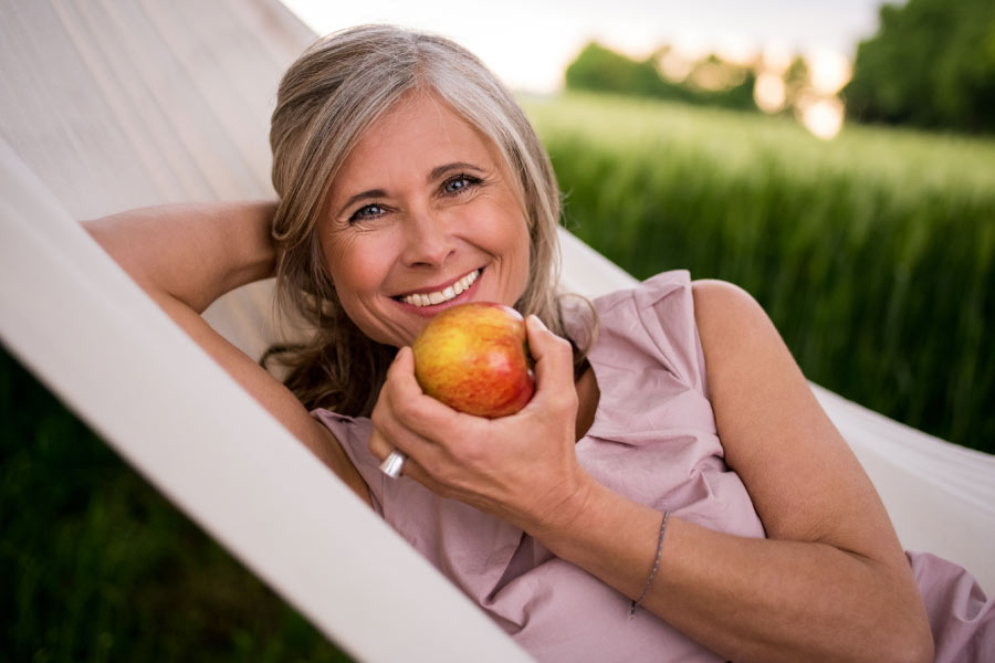 woman lounging eating an apple