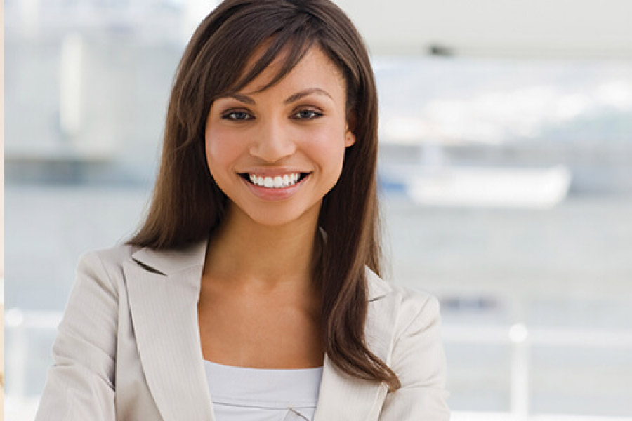 young woman smiles showing off her dental sealants