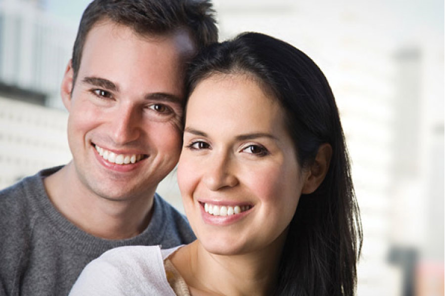 young couple smile showing off their dental veneers