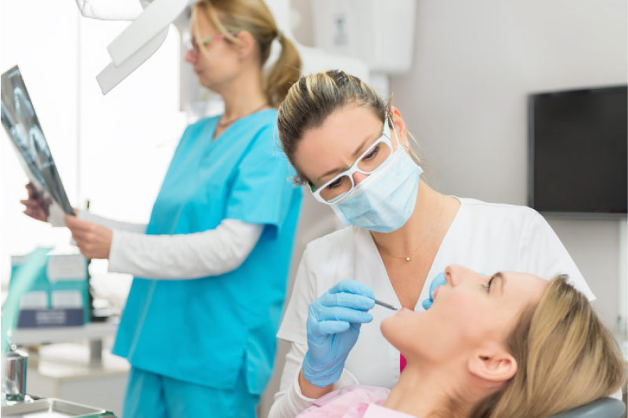 woman visits the dentist for a regular cleaning and exam